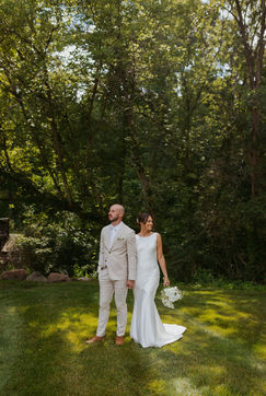 Bride and Groom in the grass for bridal portraits at Hidden Grove Estate. Best West Michigan Photographers, Downtown Grand Rapids Photography.