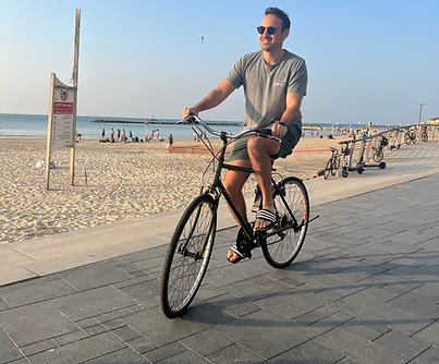 Customer on a bike at the beach in Tel Aviv