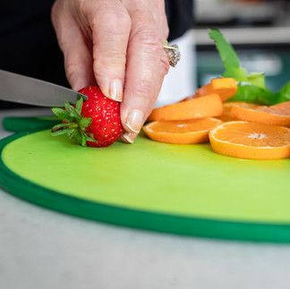 Slicing an orange and a dozen strawberries