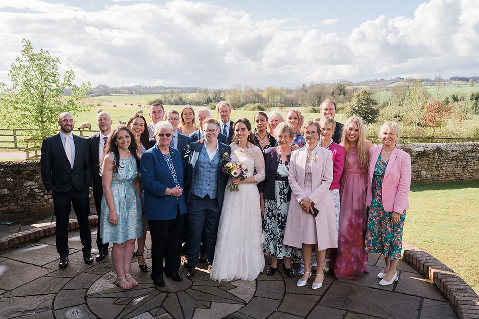 Wedding photography group shot at Dodford Manor, with the Northamptonshire countryside rolling in the background. Relaxed wedding photography. Leicester wedding photography. Covering wedding photography in Warwickshire, Staffordshire, Derbyshire, Northamptonshire, Lincolnshire, Nottinghamshire. Darley and Underwood Photography.
