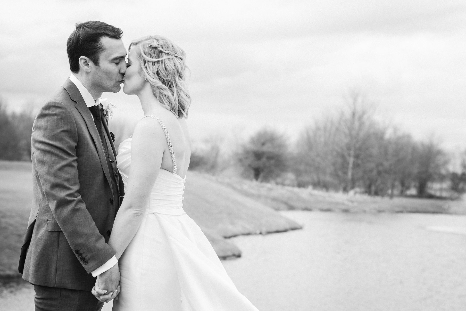 Black and white bride and groom kiss. Countryside wedding venue Nottinghamshire. 