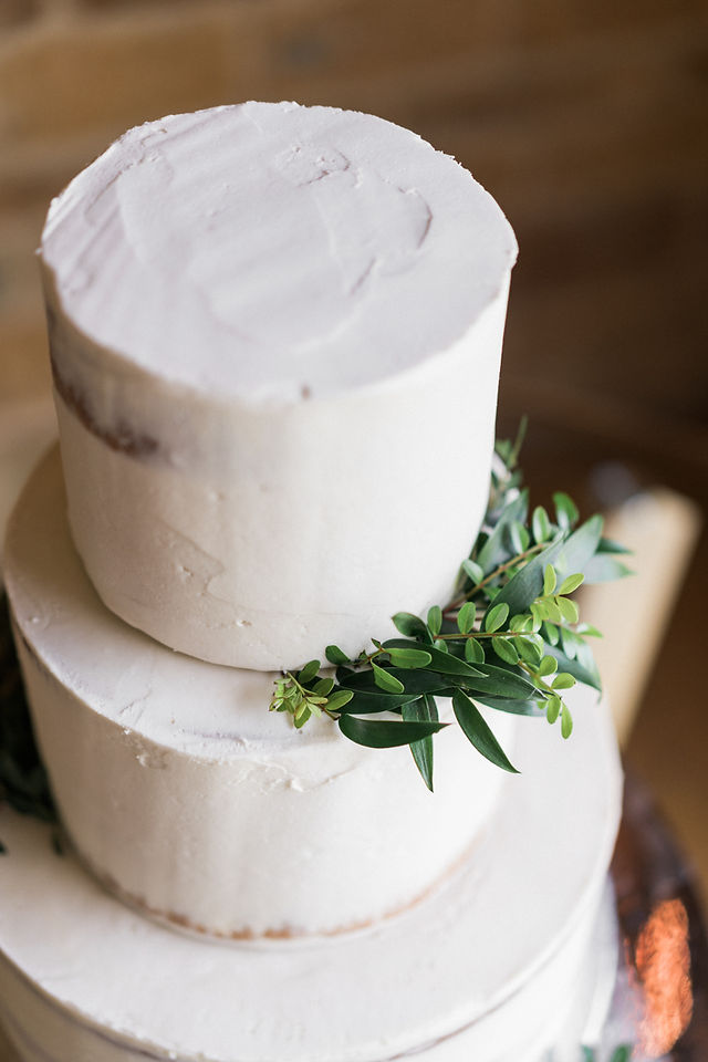 Simple, elegant wedding cake with feature greenery. Same sex wedding photography at Dodford Manor wedding venue for key workers. Natural wedding photography. Leicestershire wedding photographer. Covering wedding photography in Rutland, Nottinghamshire. Darley and Underwood Photography.