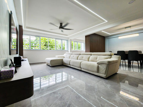 Modern living room with grey wood flooring and furniture.