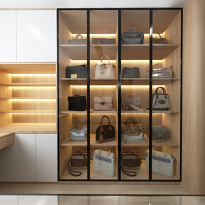 Handbag collection displayed in illuminated glass cabinet shelves