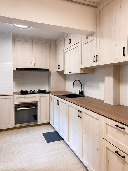 Modern kitchen with cabinetry and oven.