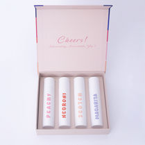 Creative product photograph of a boxed set of cosmetic lip products on a light background