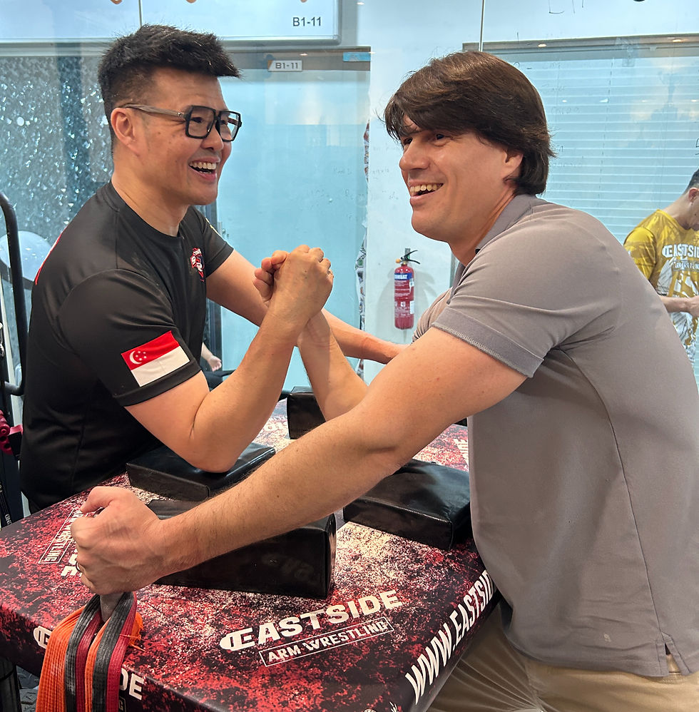 Mr. Lloret (right) sparring with Singapore Armwrestling President, Mr. Leonard Yip (left)