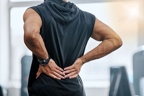 Gym, injury and man with hand on back pain for medical emergency from workout at sports st