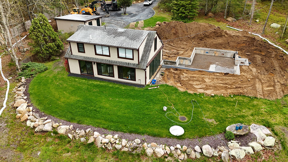 Completed Cape Cod home landscaping with green lawn and stone wall - ZZ Landscape Excavating Dennis 