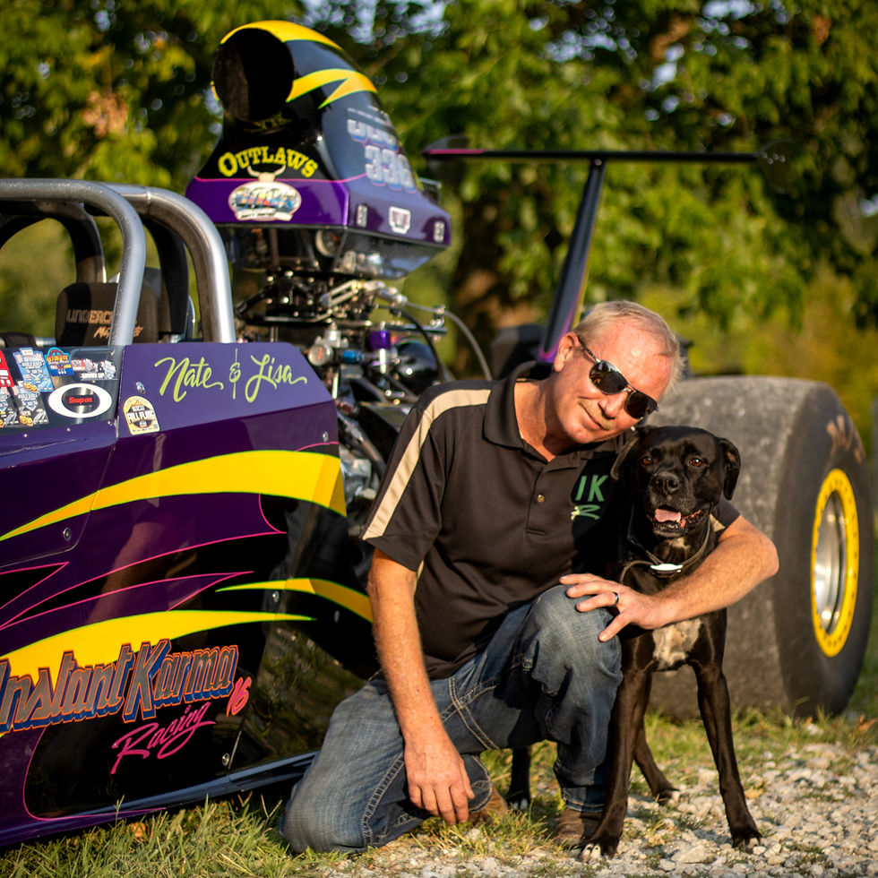 Fast Lane Boxers owner sitting next to their dragster and boxer