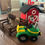 Thumbnail: crocheted green tractor with a barn, horse and fence