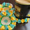 Thumbnail: three flower coasters with a coffee cup sitting on one of the coasters