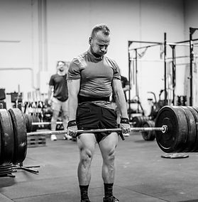 Man Deadlifting a house