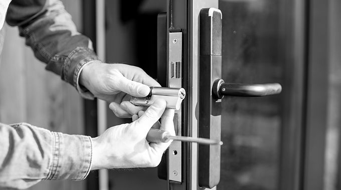 Locksmith fitting a euro cylinder to a door — lock replacement and repair services on the Crawley home page
