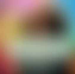 Energy Protection for Empaths. Beautiful African American woman, wearing bohemian attire, standing in a crowd, surrounded by an aura of multi-colored light shielding her from the crowd's energy. 