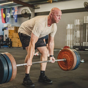 Middle aged man doing deadlifts