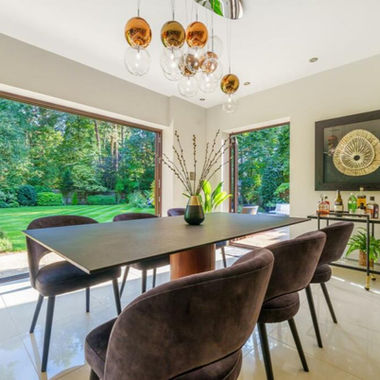 A kitchen table with pendant lighting