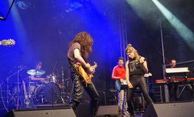 Live-Band und Sängerin bei einem Open-Air-Auftritt.