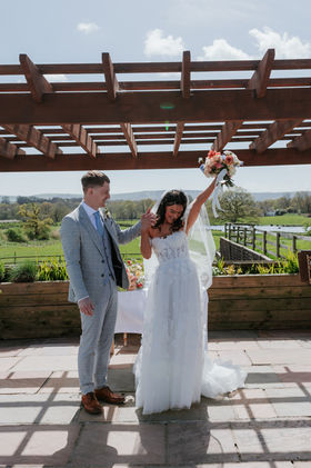 Bride and Groom Celebrate after saying I Do at their ceremony at Southlands Barn, West Sussex