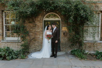 bride and groom stand outside clisold house in London