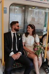 bride and groom sit on the tube together