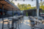 Best Buy Metals Pavilion with high top and low top black iron tables and chairs, bar with overhead coverage. 