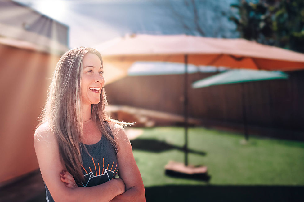 Aften outside with the sunlight behind her and rays of light casting a beautiful glow around her