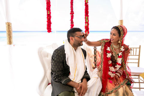 Bride and groom seated during wedding vows ceremony in Cancun.