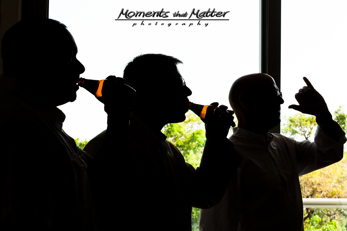 Groom getting ready in dramatic light at Grand Sirenis Riviera Maya