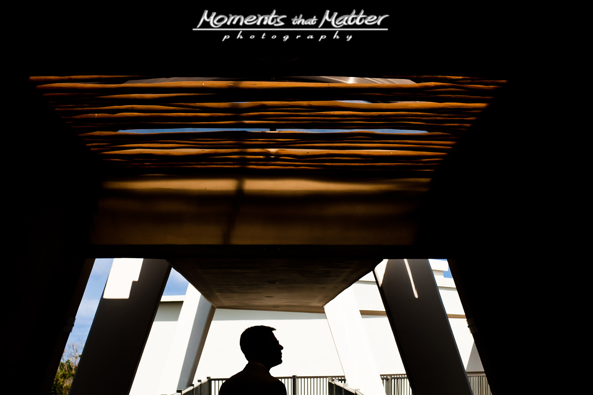 Groom portrait beneath resort architecture at Grand Sirenis Riviera Maya