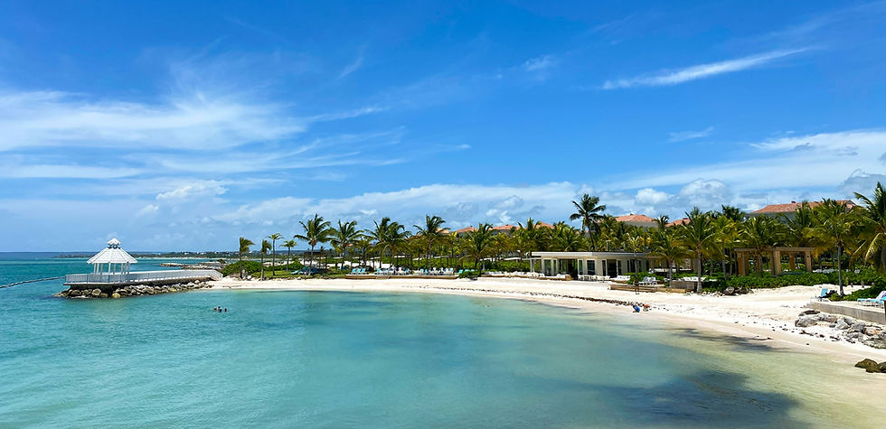 Eye-level view of turquoise water gently lapping on white sandy beach in Punta Cana
