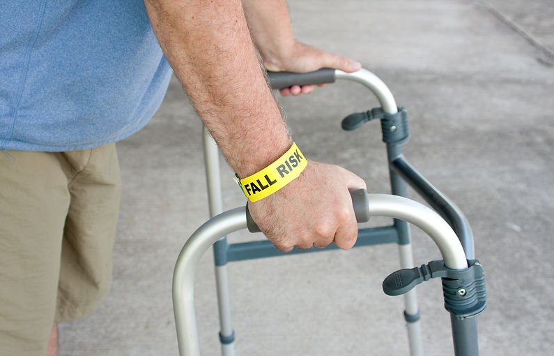 Man learning to safely walk with physical therapist