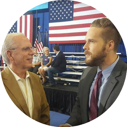 An image of two white men speaking.