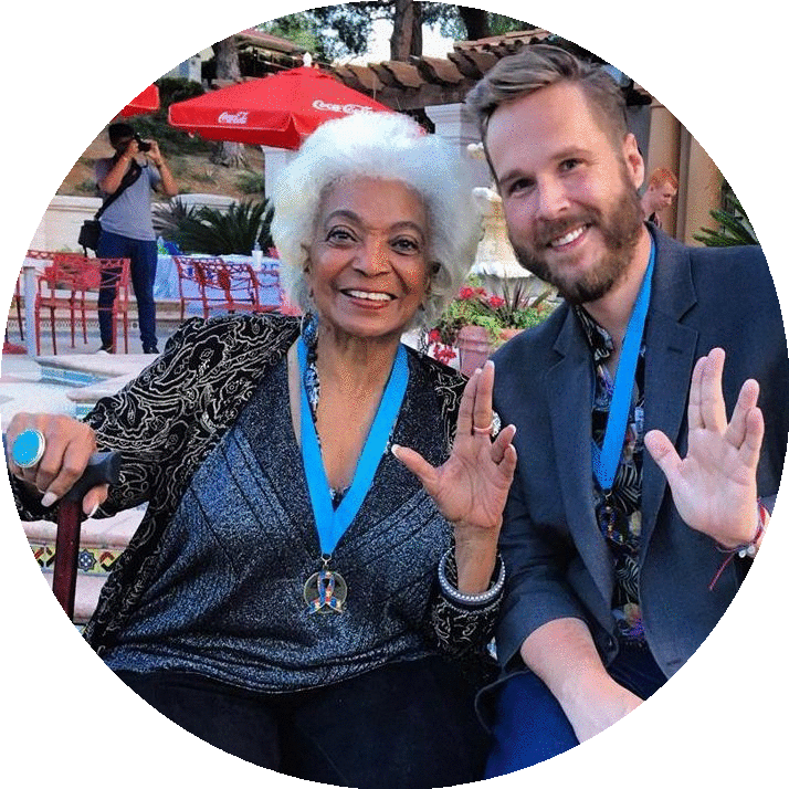 An image of actress Nichelle Nichols, a black woman alongside Pivot founder John Marble, a white man.