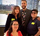 An imge of two white women, a white mn, and a Latinx man.