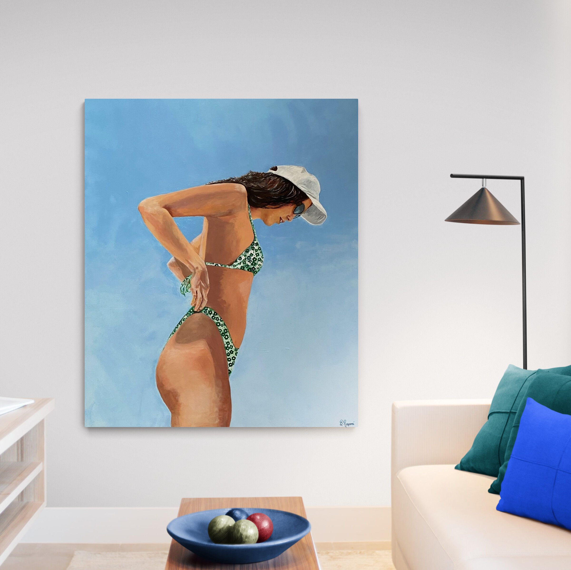 Woman in a green floral bikini stands confidently beneath a clear blue sky, adjusting her swimsuit with one hand. A white cap