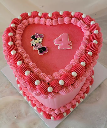 custom Minnie mouse heart-shaped cake