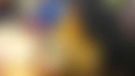 Woman in yellow tipico shirt reading a Quiche Bible.