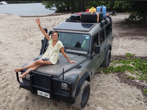 Tania sitting on bonnet waving goodbye at river mouth.png