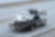 Car getting towed on flat bed