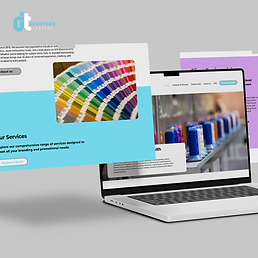Laptop displaying website design with Downtown Collective logo and color palette samples.