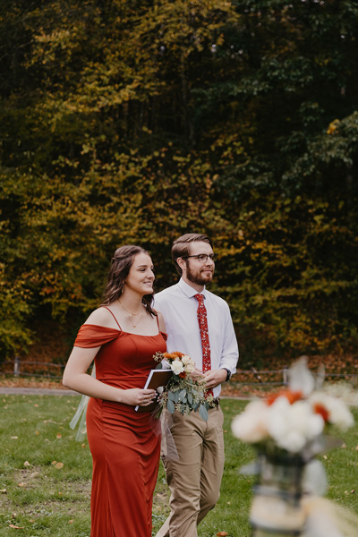 A groomsmen and bridesmaid walking