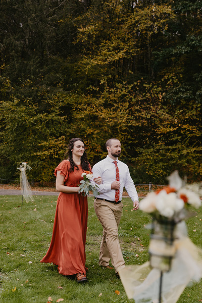 A groomsmen and bridesmaid walking