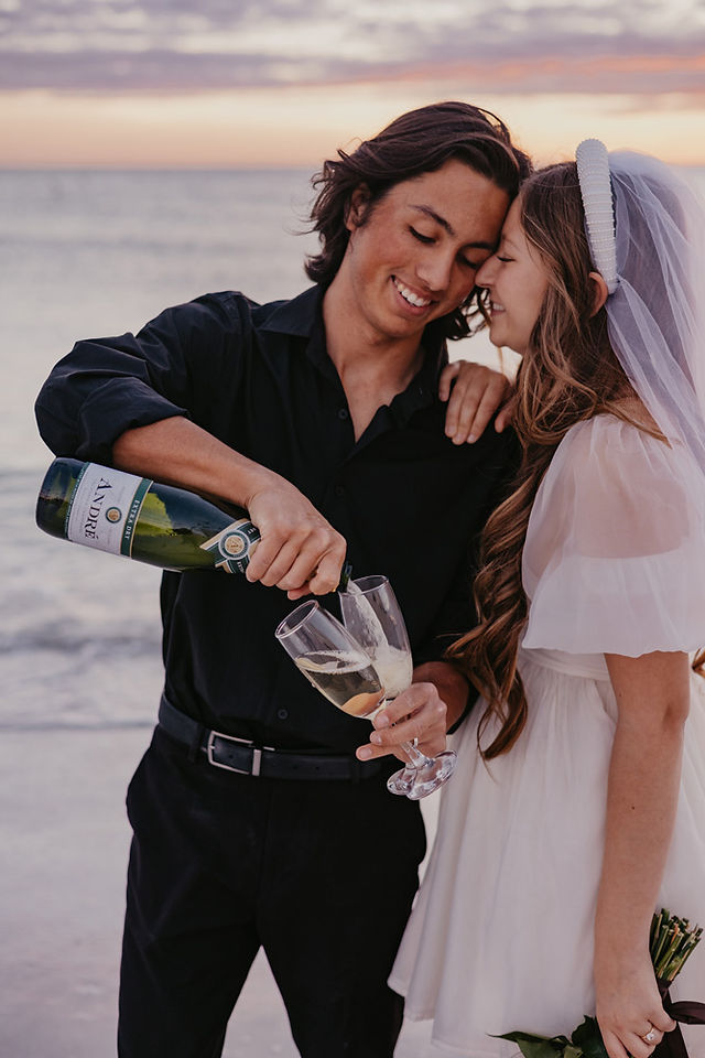 A couple pouring champagne