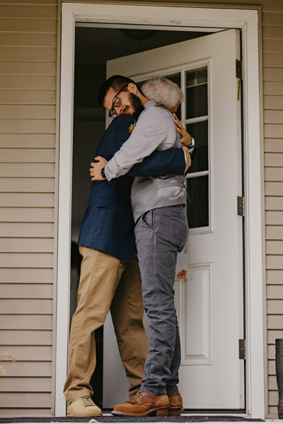 A dad and groom hugging