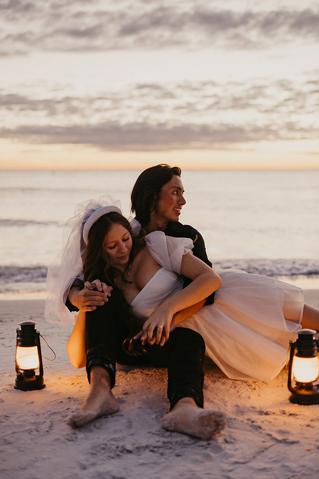 A couple laying down on a blanket