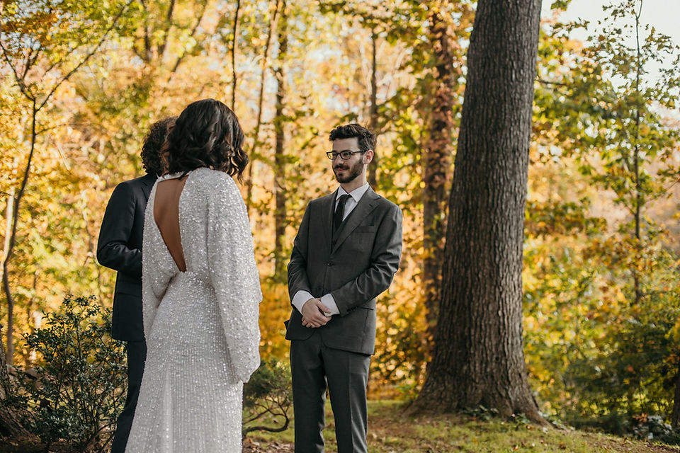 A couple standing while the officiant speaks