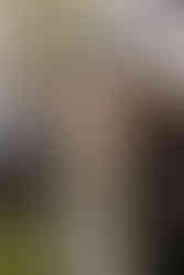 A bride and parents walking down the aisle