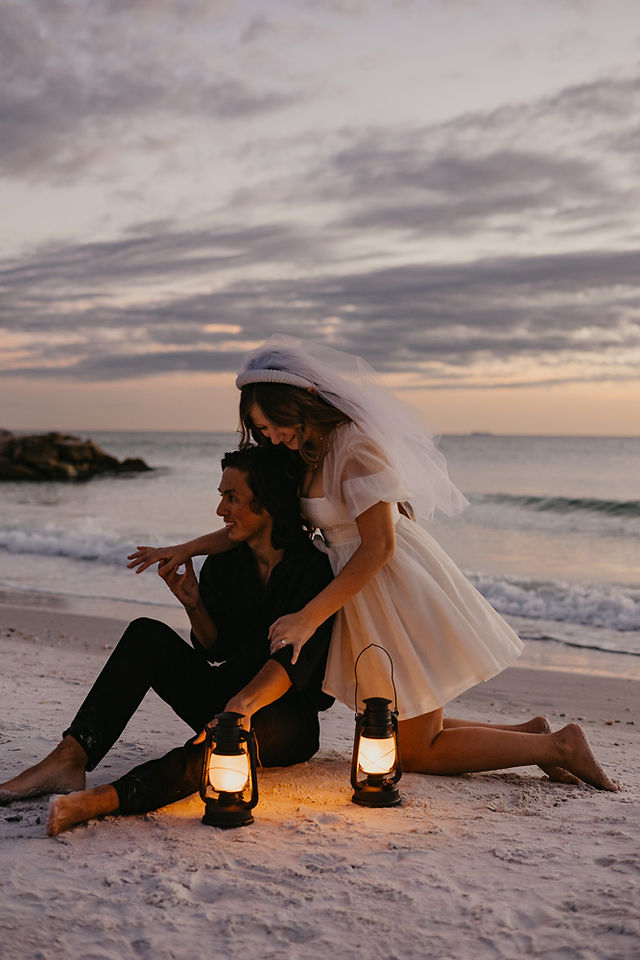 A couple laying down on a blanket