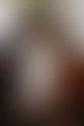 Family helping bride into shoes